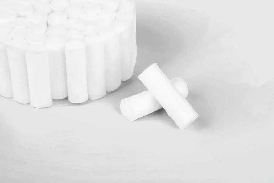 A bundle of dental cotton rolls with two loose rolls in front