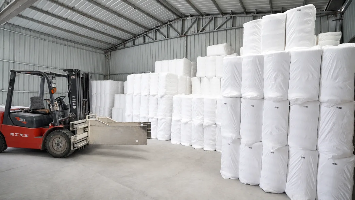 Wrapped compressed bales of finished bleached cotton stored in the warehouse