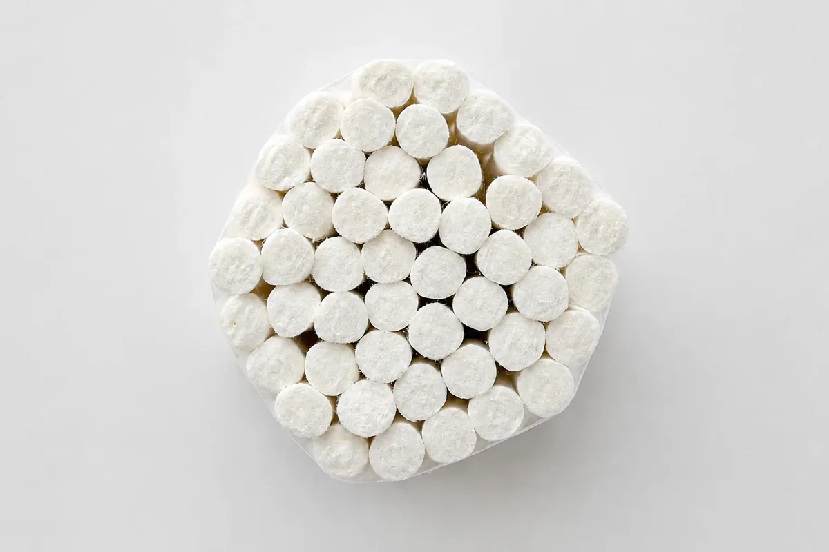 Finished disposable dental cotton rolls grouped for packing